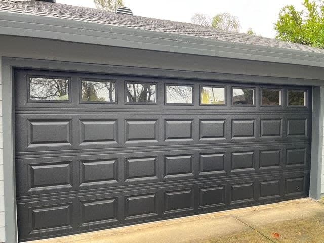 Garage door spring repair and replacement — gray sectional garage door